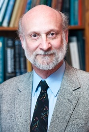 Headshot of Dr. Ratner wearing a gray suit with a dark tie